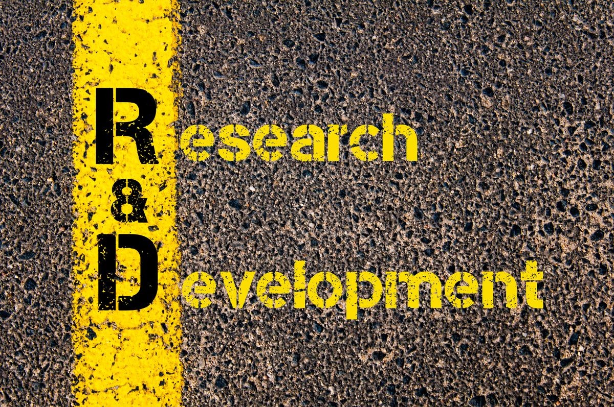 Concept image of Accounting Business Acronym R&D Research And Development written over road marking yellow paint line.