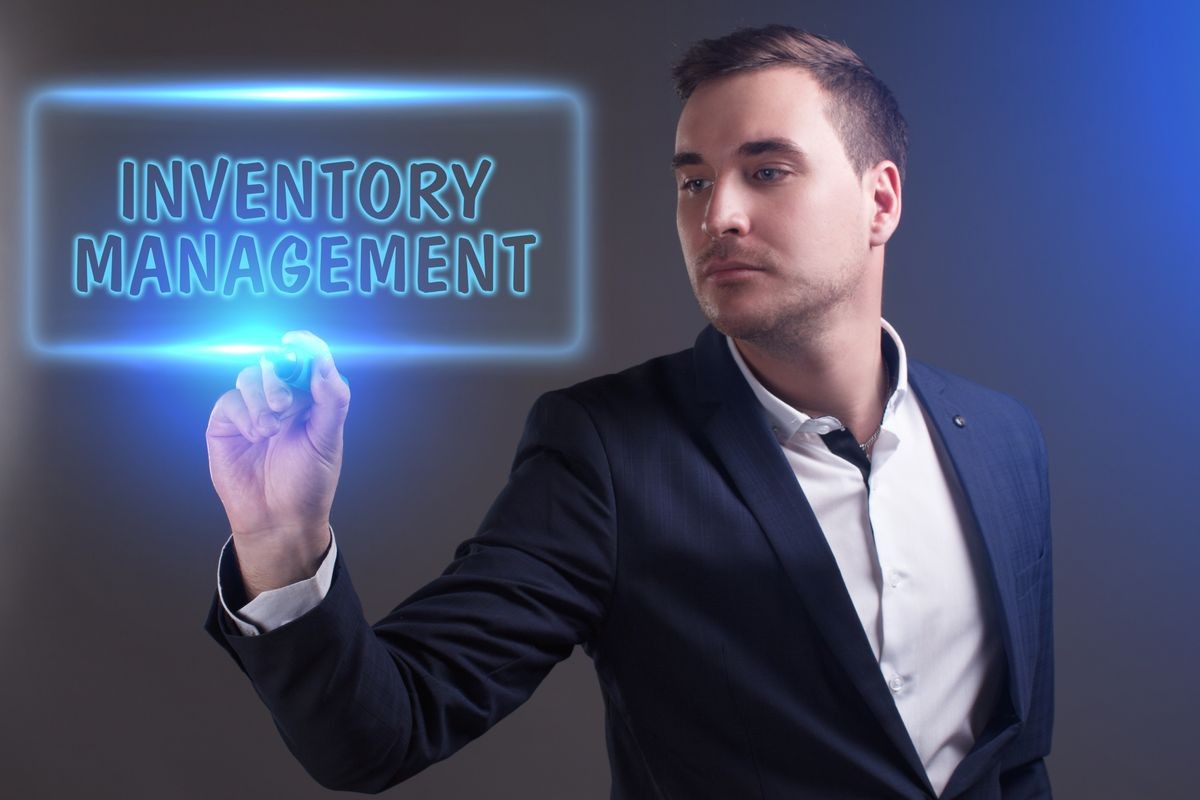 The concept of business, technology, the Internet and the network. Young businessman showing inscription: Inventory management